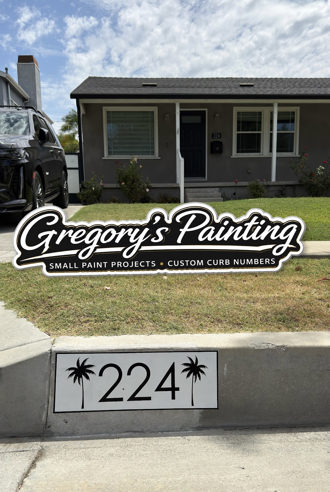 White curb number 224 between painted palm trees